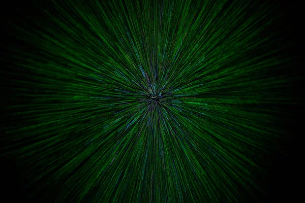 Natural lens zoom explosion radial blurred green particles on black background with selective focus — Stock Photo, Image
