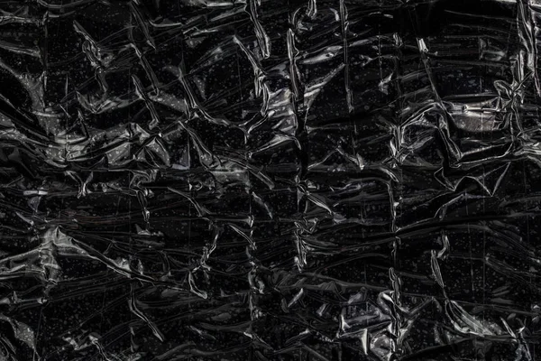 Чорна поліетиленова плівка, що має липку стрічку, плоска контрабандна упаковка крупним планом текстура — стокове фото