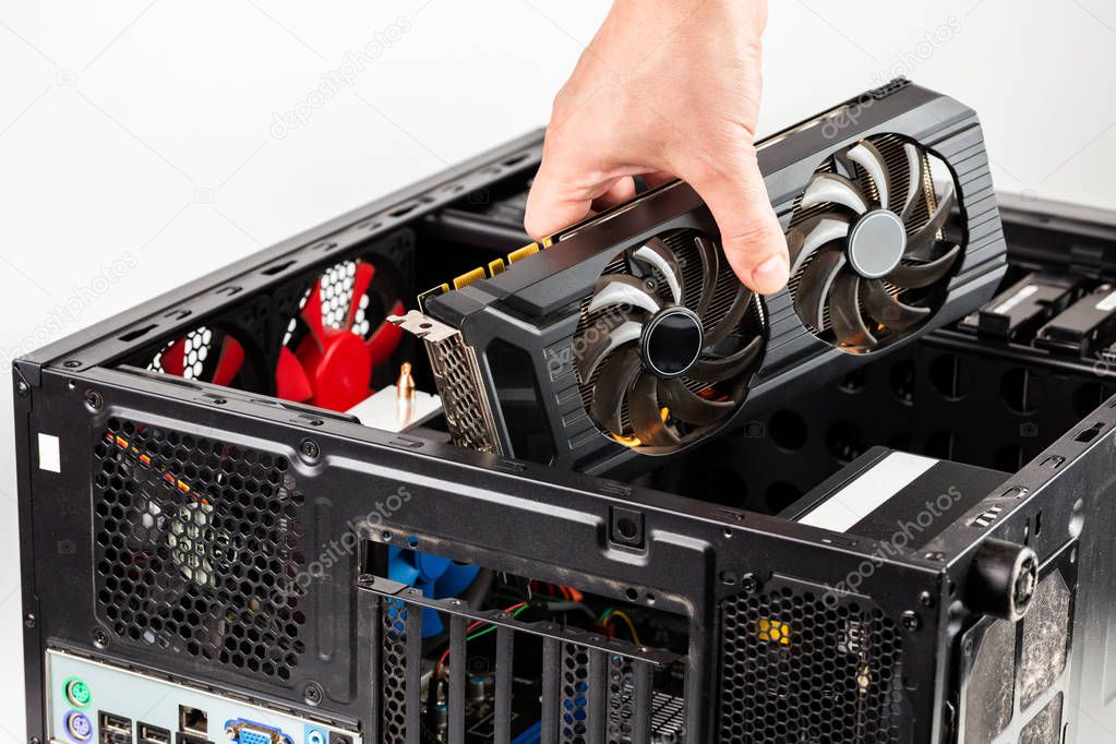 hand plugging a video card while maintenance personal computer hardware with selective focus