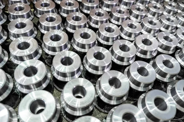Batch of shiny round steel parts background, close-up with selective focus and blur — Stock Photo, Image