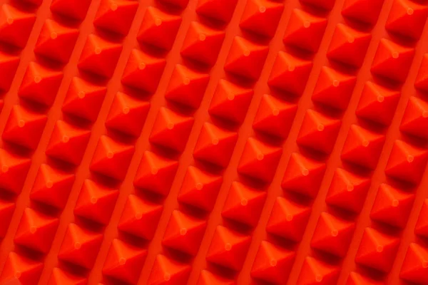 Abstract rood siliconen piramides array close-up achtergrond — Stockfoto