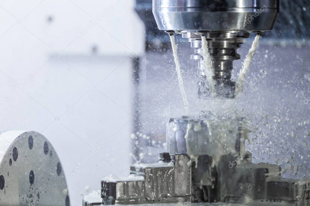 a process of industrial wet milling in 5-axis cnc machine with coolant flow under pressure and freezed splashes