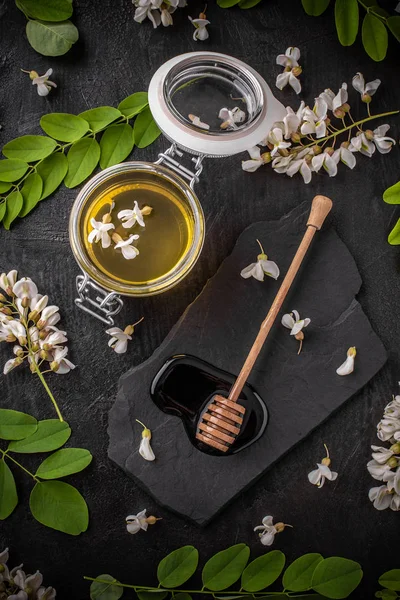 Komposition Mit Honig Akazienblüten Und Honiglöffel Auf Schwarzem Hintergrund — Stockfoto