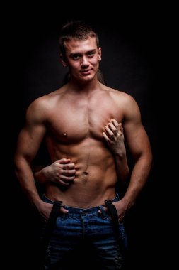 Karanlık bir arka plan üzerinde kas gömleksiz adam dokunmadan eller
