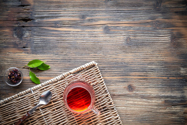 Flat lay view of cup of tea on vintage wooden background