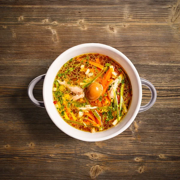 Flat lay of rooster soup with smoked quail egg and crunchy vegetables on wooden background — Stock Image Flat Lay Rooster Soup Smoked Quail Egg Crunchy Vegetables Wooden Royalty Free Stock Images