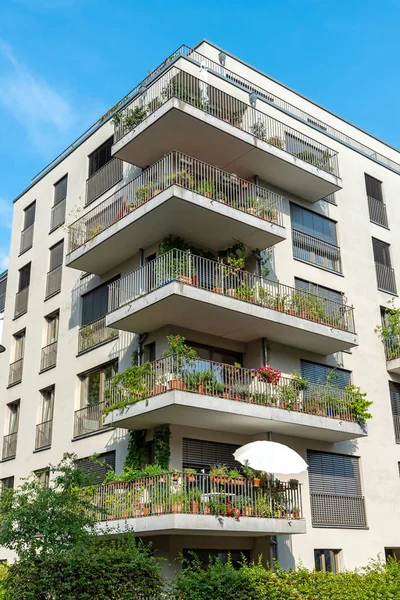 Gray multi-family house with balconies seen in Berlin, Germany