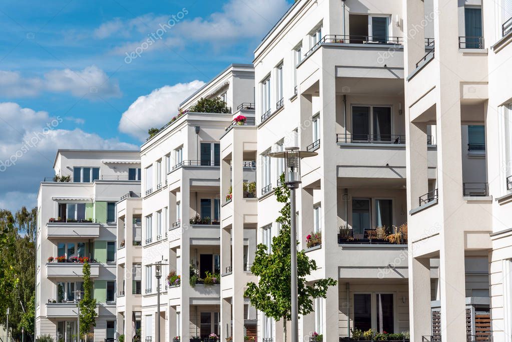 The facade of some white modern apartment buildings seen in Berlin, Germany