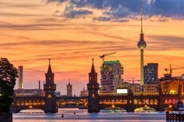 Berlin'deki Oberbaum Köprüsü'nde arkadaki ünlü Televizyon Kulesi ile dramatik gün batımı