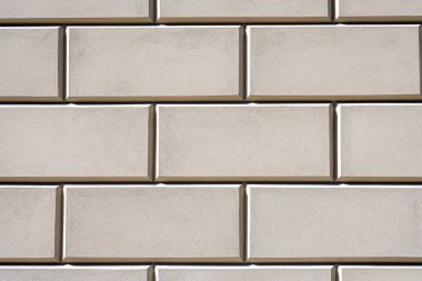 Bej taş levhalı bir duvardan arka plan