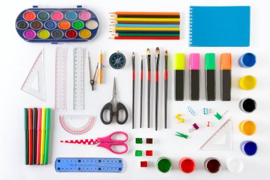 Set of school supplies on white background. Paint, pencils, notepad, brushes, scissors. Top view. clipart