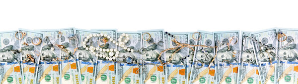 Top view of American dollars and gold jewelry isolated on white