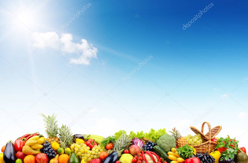 Variety vegetables and fruits against blue sky