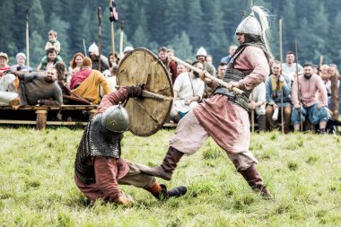 KYMRY ,RUSSIA - JULY 26 2018 Festival battle reenactors of ancient medieval warriors clipart