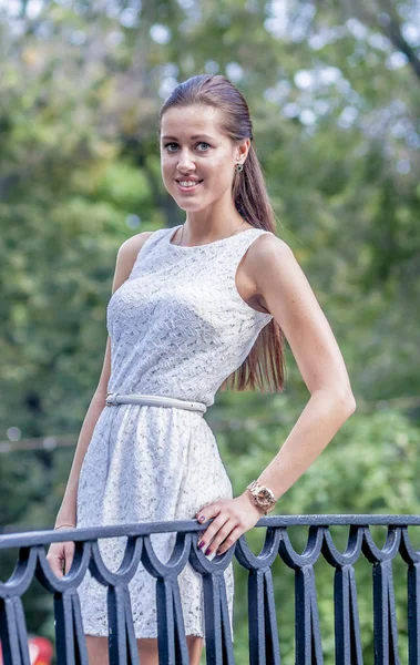 stock image Young girl in a white dress in a summer park