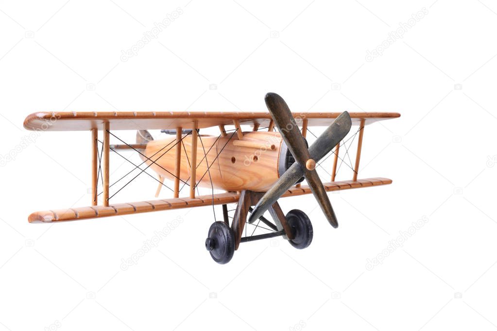 Close up of an old wood toy plane on a white background