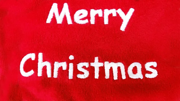 Makroaufnahme Eines Gestickten Weihnachtsschildes Mit Weißen Buchstaben Und Rotem Hintergrund — Stockfoto