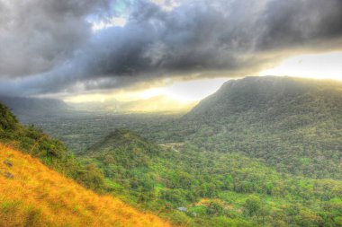 Beautiful view of the mountains with the sun coming out at El Valle de Anton, Panama,HDR Rendering clipart