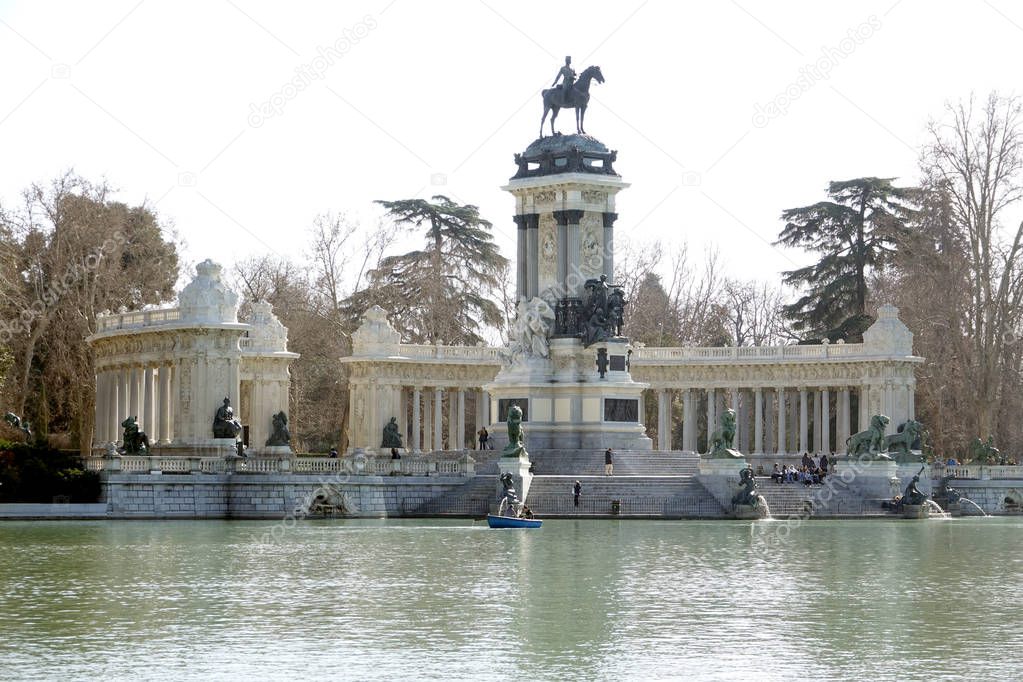 MADRID-SPAIN-FEB 19, 2019: The Monument to Alfonso XII is located in Buen Retiro Park (El Retiro), Madrid, Spain. The monument is situated on the east edge of an artificial lake near the center of the park.