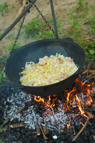 heating kettle with food on fire. beginning cooking