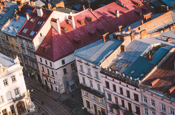 Top view of the roof of an old European city - Lviv. Old architecture, old metal rusted roofs, view of the city from the town hall at sunset