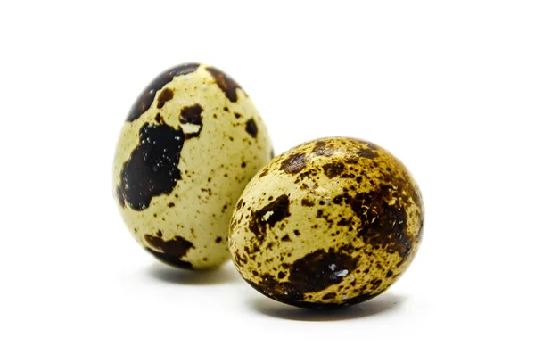 Two small quail eggs in a brown speck isolated on a white backgr — Stock Photo, Image