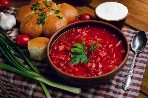 Ukrainian national cuisine - red borsch with donuts in a clay bo