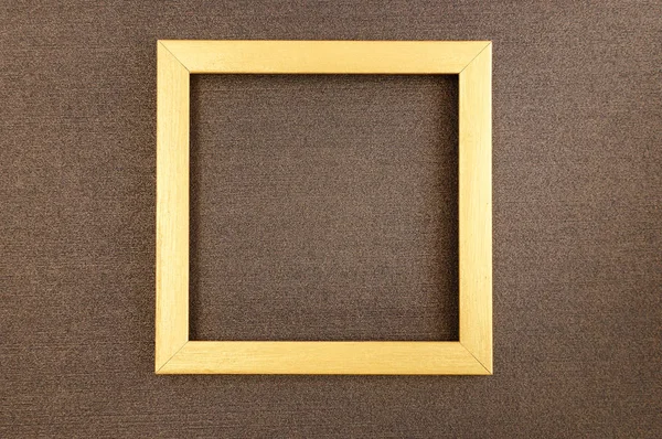 Golden square frame on brown mother-of-pearl designer cardboard. — Stock Photo, Image