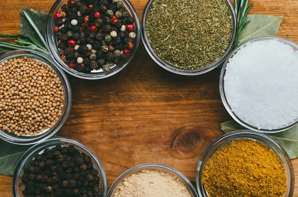 Variety of spices in round glass bowls - ground ginger, hops-sun