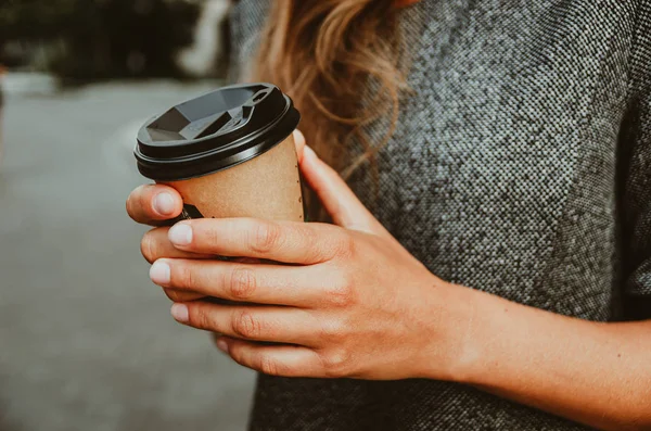 Mano femminile tiene una tazza di carta con caffè . — Foto Stock
