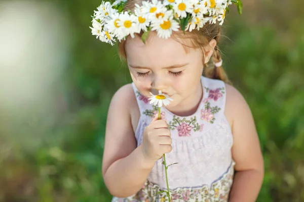 Un niño con una corona de flores . — Foto de Stock