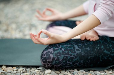 Bir kadın doğada yoga yapıyor..