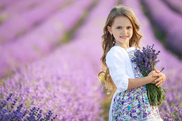 Schöne Mädchen in einem Feld mit Lavendel. — Stockfoto