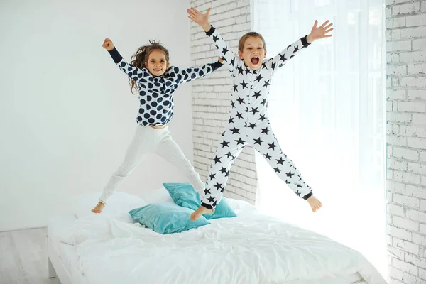 Barn hoppar på sängen. — Stockfoto