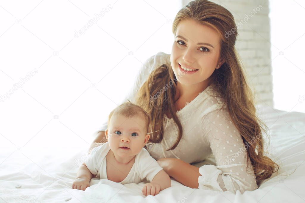 Small child with a woman. Baby with mom. 