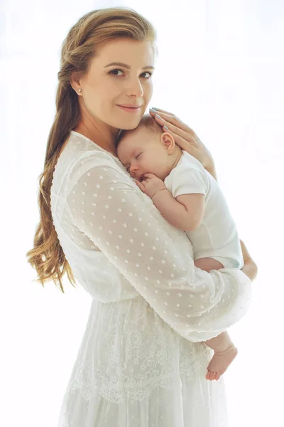 Small child with a woman. Baby with mom. Stock Image