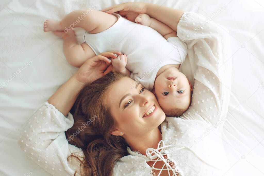 Small child with a woman. Baby with mom. 