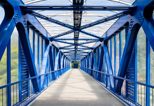 Interior of empty metallic elevated footbridge in the Moscow city.