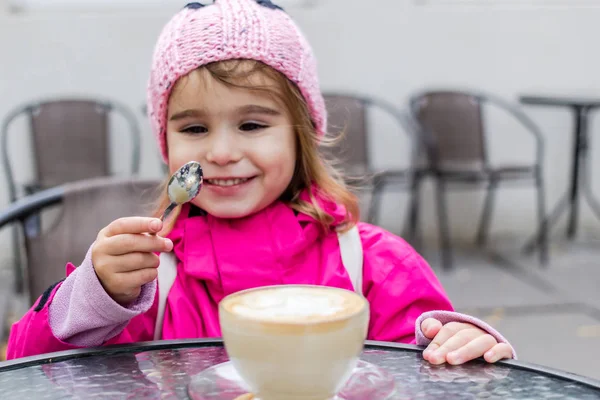 Little girl fooling around with coffee. — Stock Photo, Image