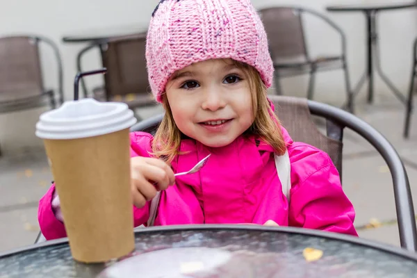 Little girl fooling around with coffee. — Stock Photo, Image