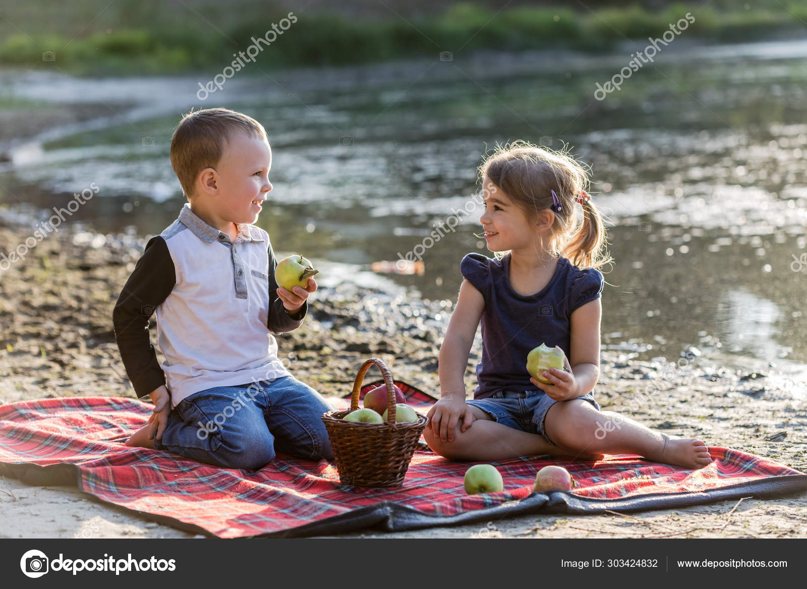 Happy kids with apples having fun on the beach. Stock Photo by ©Alex
