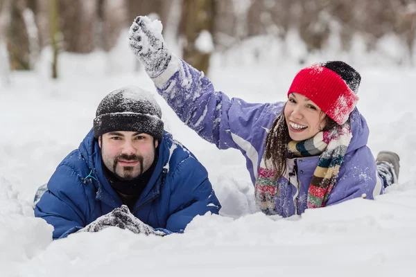 Boy and girl having fun in snow at winter — Stock Photo, Image