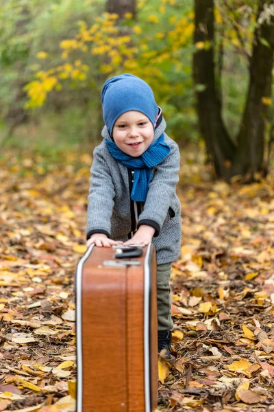 Little boy playing in autumn forest — Stock Photo, Image