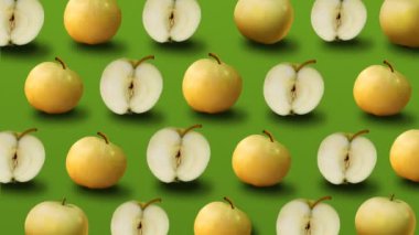 Taze sarı elma yeşil arka plan üzerinde renkli meyve deseni. 4k video.