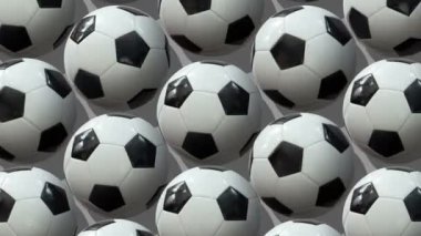 Büyük bir futbol topu grubu. Toplar eksenlerinin etrafında döner. Düz yerde, üst tarafta. Isome Manzarası. Kusursuz döngü videosu. 