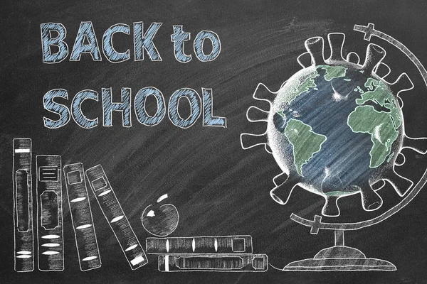 Back to School lettering, books and globe in shape of coronavirus  are drawn with chalk on a blackboard. Covid-19 concept. Start of the new school year 2020