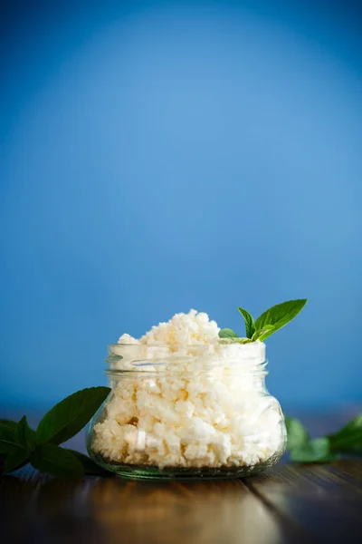 Fresh homemade cottage cheese in a glass jar — Stock Photo, Image