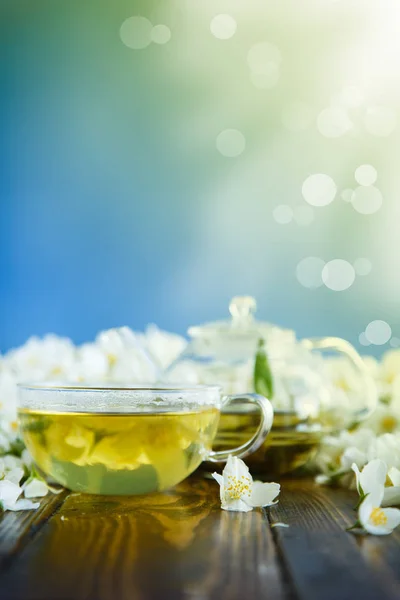 茶几上的玻璃茶壶里有茉莉花花的茶 — 图库照片