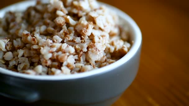 Buckwheat boiled in a ceramic bowl — Stock Video