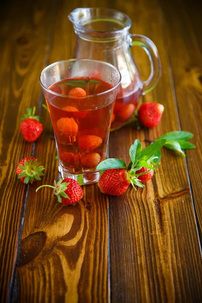 Sweet compote of ripe red strawberries in a glass decanter — Stock Photo, Image